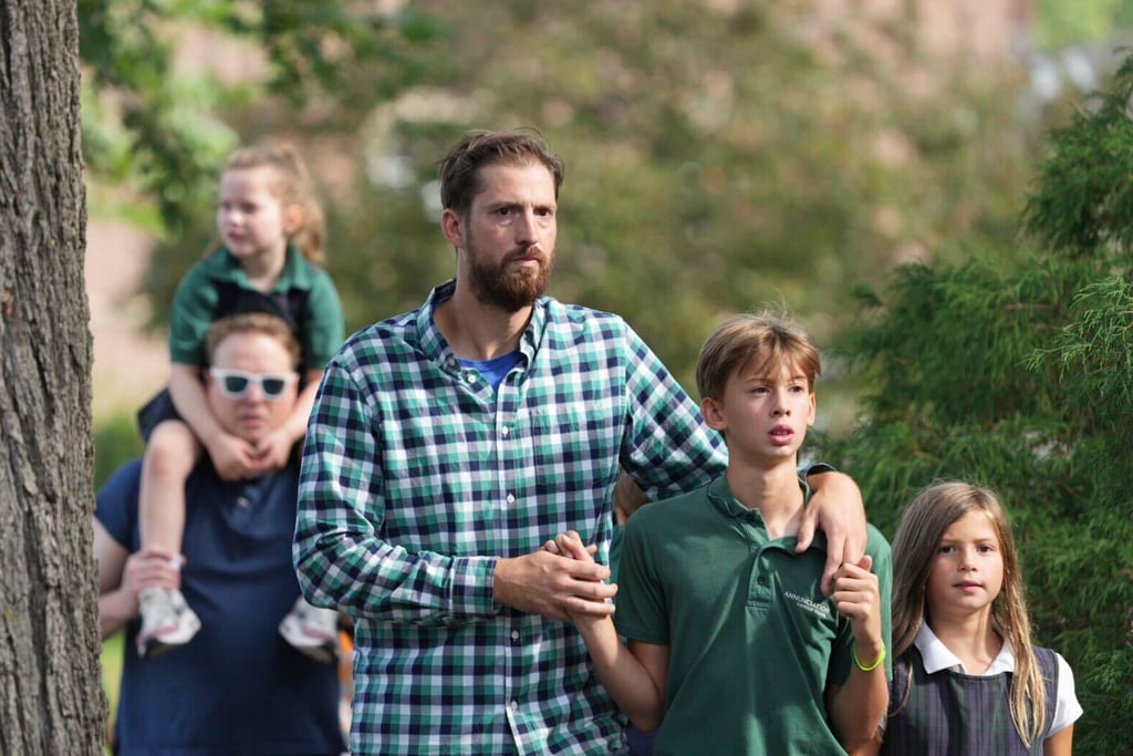 Parents comfort their children after a shooting at the Annunciation Catholic School on Wednesday, Aug. 27, 2025, in Minneapolis. (Alex Kormann/Star Tribune via AP)