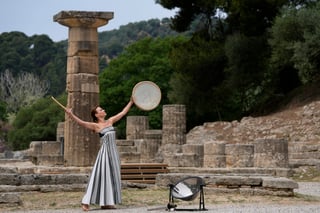A performer takes part in the official ceremony of the flame lighting for the Paris Olympics, at the Ancient Olympia site, Greece, Tuesday, April 16, 2024. The flame will be carried through Greece for 11 days before being handed over to Paris organizers on April 26. (AP Photo/Thanassis Stavrakis)