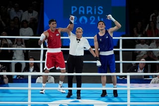 Uzbekistan's Asadkhuja Muydinkhujaev, left, celebrates after defeating Mexico's Marco Verde in their men's 71 kg final boxing match at the 2024 Summer Olympics, Friday, Aug. 9, 2024, in Paris, France. (AP Photo/John Locher)