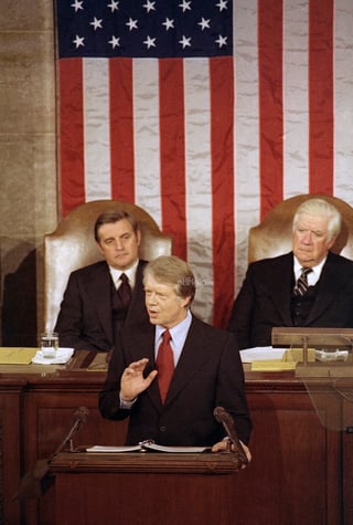 FILE - President Jimmy Carter speaks about energy before a joint session of the Congress in Washington, April 21, 1977. House speaker Thomas 'Tip' O'Neill is at right, and Vice President Walter Mondale is at left. (AP Photo, File)