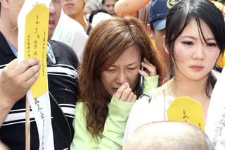 Cuerpos. Los familiares de las víctimas del avionazo en Taiwán esperan más informes para la entrega de cuerpos. (EFE)
