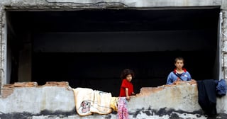 Escenario actual. Dos niños sirios refugiados en un edificio a media construcción en Turquía. (EFE)