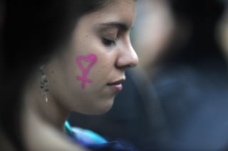No más muertes. Una mujer es captada cerrando los ojos, mientras se manifiesta contra el feminicidio en Argentina.