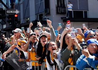 Miles de aficionados en Oakland poblaron las calles de la ciudad para ver el paso del campeón.  (AP y EFE)