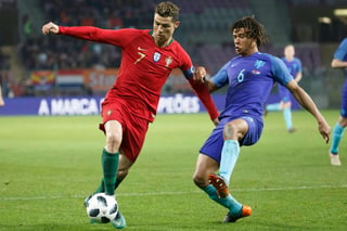 El portugués Cristiano Ronaldo (i) disputa el balón con Nathan Ake de Holanda durante el partido amistoso internacional. (EFE)