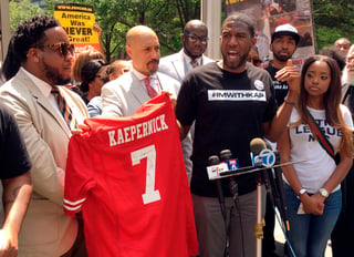 Jumaane D. Williams, asambleísta de Nueva York, y Kirsten John Foy, director regional de la organización National Action Network, sostienen un jersey del exjugador de la NFL Colin Kaepernick, durante una protesta. (AP)