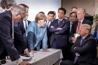 Imagen cedida por el gobierno alemán y tomada ayer durante la reunión del G7 en LaMalbaie, Canadá, se observa en primer plano al centro a Angela Merkel, canciller federal de Alemania, frente a un Donald Trump, presidente de EU, sentado, que escucha a su homólogo francés, EmmanuelMacron, a la izquierda de Merkel. Completan la escena Shinzo Abe, primer ministro japonés (centro derecha); John Bolton, consejero de Seguridad Nacional (derecha); Theresa May, primera ministra de Reino Unido (a la izquierda de Macron), y el consejero económico de Trump, Larry Kudlow (izquierda). 