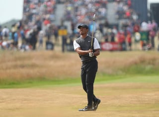 El estadounidense Tiger Woods mira su disparo en el fairway del sexto hoyo ayer, en la tercera ronda del Abierto Británico en Carnoustie, Escocia. (AP)
