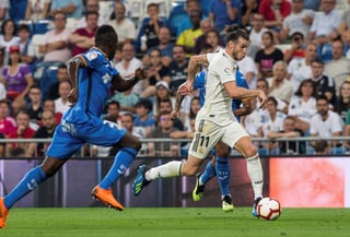 El delantero galés del Real Madrid Gareth Bale (d) se escapa del togolés Djené Dakonam. Bale responde con gol en triunfo