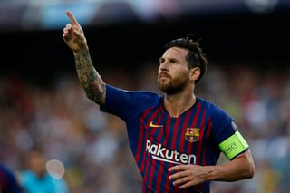 El argentino Lionel Messi festeja luego de anotar el primer tanto del Barcelona ante el PSV de Eindhoven, en un partido de la Liga de Campeones de Europa.