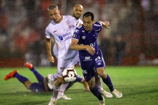 Rodriguinho Marinho (d), de Cruzeiro, disputa el balón con Israel Damonte, de Huracán, ayer durante un partido de la Copa Libertadores.