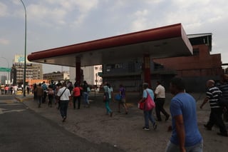 Decenas de personas se desplazan a pie y esperan autobuses debido a la suspensión del Metro por un apagón en Caracas. (EFE)