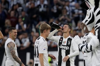 Cristiano Ronaldo (d), de Juventus, festeja la obtención del título de la Serie A tras vencer 2-1 a la Fiorentina. (AP)