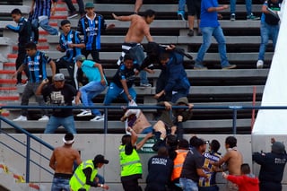 Aficionados queretanos golpean a un hincha rival durante el partido que enfrentó al Atlético de San Luis y los Gallos Blancos. (JAM MEDIA) 