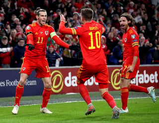 De la mano de Aaron Ramsey (c) y liderados por Gareth Bale (i), los galeses confirmaron su presencia en el torneo que se realizará el próximo año. (AP)