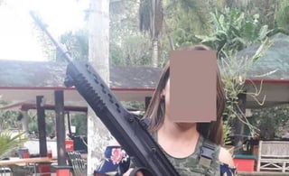  La secretaria del Ayuntamiento de Teocelo, Veracruz, Trinidad Martínez Larios posó portando un arma de uso exclusivo del Ejército, lo que le ha generado duras críticas en redes sociales. (ESPECIAL)
