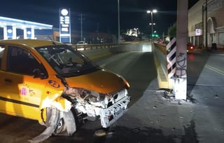 Un taxi fue abandonado por su conductor tras impactar un poste metálico en la entrada al Sistema Vial Alianza de la ciudad de Torreón. (EL SIGLO DE TORREÓN)