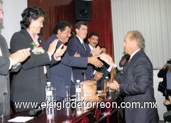 Carlos Román Cepeda recibiendo su reconocimiento de mano de las autoridades académicas y gubernamentales.