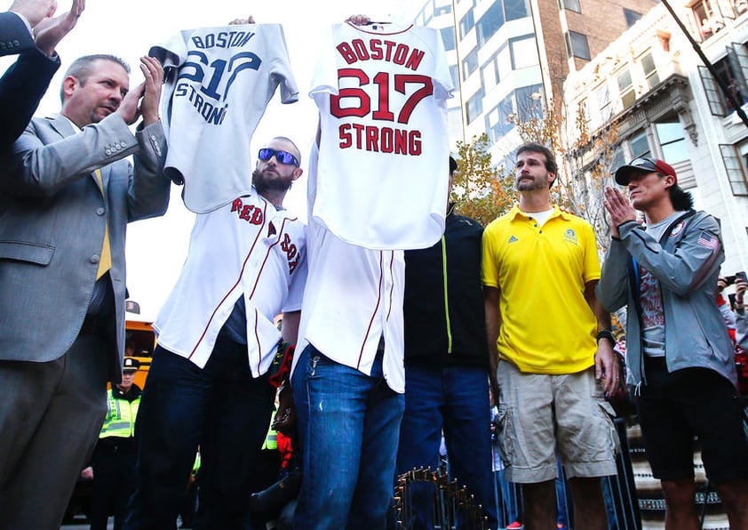 El jardinero Jonny Gomes colocó el trofeo de Serie Mundial en la raya, y junto con el catcher Jarrod Saltalamacchia, levantaron camisetas de los Medias Rojas con las palabras "BOSTON STRONG" y el número 617, el código de área de la ciudad.