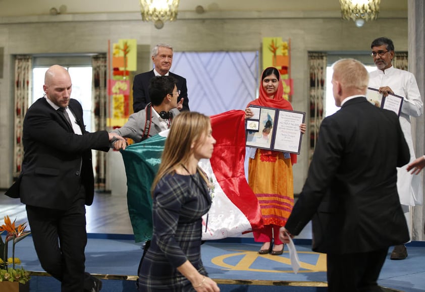 El activista irrumpió en el Ayuntamiento de Oslo, Noruega, con la bandera que tenía una mancha roja debajo del águila.