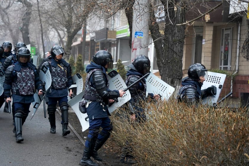 Riot police walk to block demonstrators during a protest in Almaty, Kazakhstan, Wednesday, Jan. 5, 2022. Demonstrators denouncing the doubling of prices for liquefied gas have clashed with police in Kazakhstan's largest city and held protests in about a dozen other cities in the country. (AP Photo/Vladimir Tretyakov)