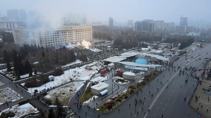 Smoke rises from the city hall building during a protest in Almaty, Kazakhstan, Wednesday, Jan. 5, 2022. News outlets in Kazakhstan are reporting that demonstrators protesting rising fuel prices broke into the mayor's office in the country's largest city and flames were seen coming from inside. Kazakh news site Zakon said many of the demonstrators who converged on the building in Almaty on Wednesday carried clubs and shields. (AP Photo/Yan Blagov)