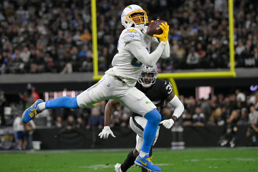 Los Angeles Chargers wide receiver Mike Williams (81) makes a catch against the Las Vegas Raiders during the second half of an NFL football game, Sunday, Jan. 9, 2022, in Las Vegas. (AP Photo/David Becker)