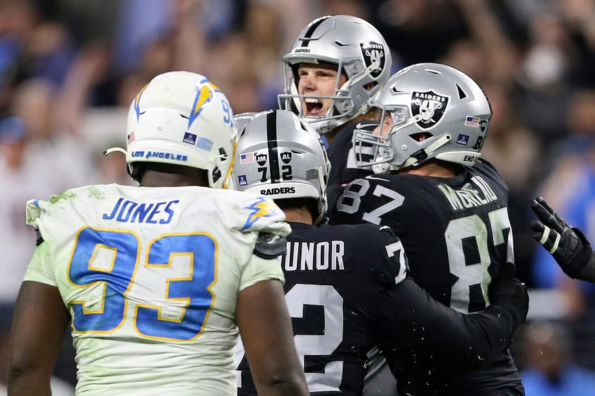 Las Vegas Raiders kicker Daniel Carlson, center, celebrates after kicking the game-winning field goal against the Los Angeles Chargers during overtime of an NFL football game, Sunday, Jan. 9, 2022, in Las Vegas. (AP Photo/Ellen Schmidt)