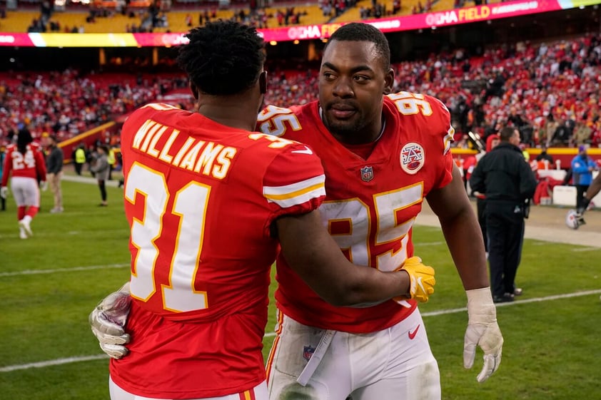 Kansas City Chiefs running back Darrel Williams (31) walks off the field with teammate Chris Jones (95) at the end of the AFC championship NFL football game against the Cincinnati Bengals, Sunday, Jan. 30, 2022, in Kansas City, Mo. The Bengals won 27-24 in overtime. (AP Photo/Charlie Riedel)