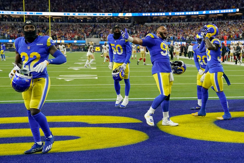 Los Angeles Rams’ David Long Jr. (22), Ernest Jones (50) and Aaron Donald celebrate with teammates after the NFC Championship NFL football game against the San Francisco 49ers Sunday, Jan. 30, 2022, in Inglewood, Calif. The Rams won 20-17 to advance to the Super Bowl. (AP Photo/Mark J. Terrill)