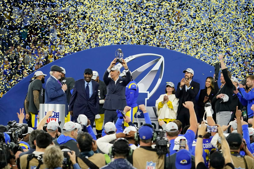 Los Angeles Rams owner Stan Kroenke, middle, holds up the George Halas trophy after the Rams defeated the San Francisco 49ers in the NFC Championship NFL football game Sunday, Jan. 30, 2022, in Inglewood, Calif. The Rams won 20-17 to advance to the Super Bowl. (AP Photo/Elaine Thompson)