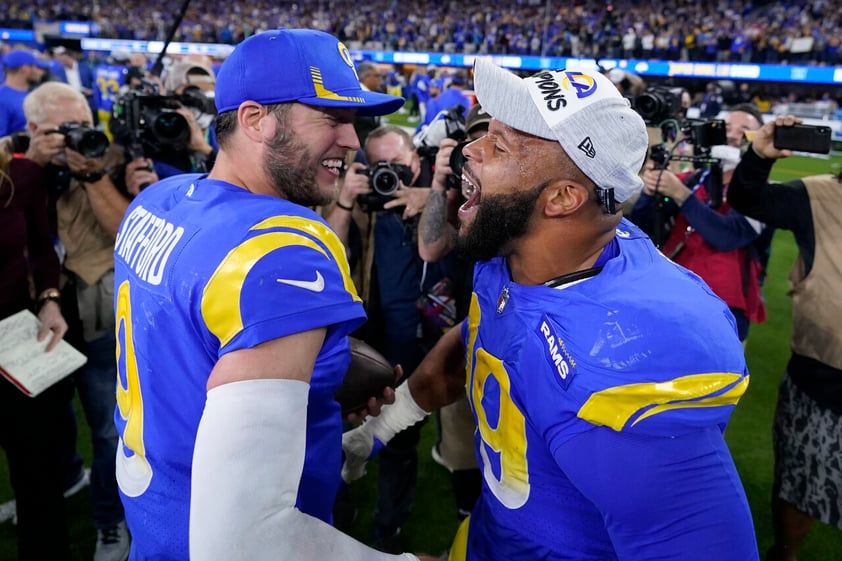 Los Angeles Rams' Matthew Stafford, left, and Aaron Donald celebrate after the NFC Championship NFL football game against the San Francisco 49ers Sunday, Jan. 30, 2022, in Inglewood, Calif. The Rams won 20-17 to advance to the Super Bowl. (AP Photo/Marcio Jose Sanchez)