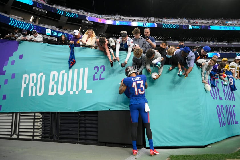 NFC wide receiver Mike Evans (13), of the Tampa Bay Buccaneers, gives autographs to fans during halftime of the Pro Bowl NFL football game against the AFC, Sunday, Feb. 6, 2022, in Las Vegas. (AP Photo/David Becker)