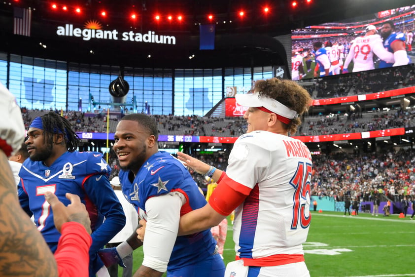 AFC quarterback Patrick Mahomes, right, of the Kansas City Chiefs, greets NFC inside linebacker Micah Parsons, center, of the Dallas Cowboys, after the Pro Bowl NFL football game at Allegiant Stadium, Sunday, Feb. 6, 2022, in Las Vegas. (AP Photo/David Becker)