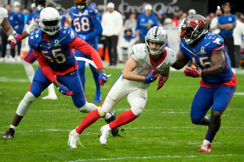 AFC wide receiver Hunter Renfrow, center, of the Las Vegas Raiders, runs the ball against the NFC during the second half of the Pro Bowl NFL football game, Sunday, Feb. 6, 2022, in Las Vegas. (AP Photo/Rick Scuteri)