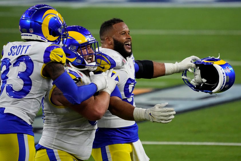 Los Angeles Rams defensive end Aaron Donald, right, celebrates with teammates after the NFL Super Bowl 56 football game against the Cincinnati Bengals, Sunday, Feb. 13, 2022, in Inglewood, Calif. (AP Photo/Elaine Thompson)