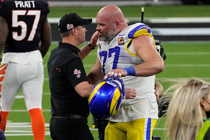 Cincinnati Bengals head coach Zac Taylor embraces Los Angeles Rams offensive tackle Andrew Whitworth (77) after the NFL Super Bowl 56 football game Sunday, Feb. 13, 2022, in Inglewood, Calif. The Los Angeles Rams won 23-20.(AP Photo/Tony Gutierrez)