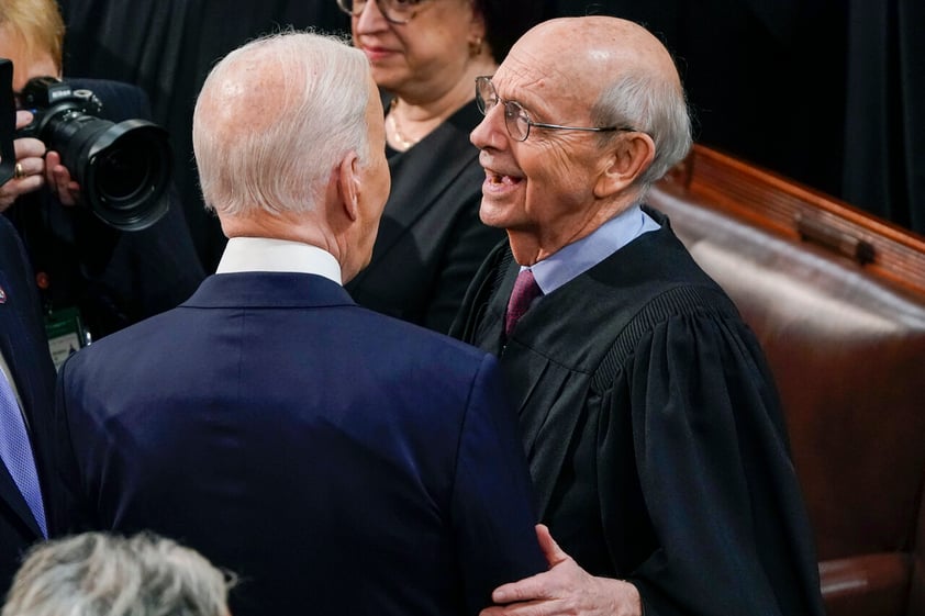 President Joe Biden talks with retiring Supreme Court Associate Justice Stephen Breyer after his first State of the Union address to a joint session of Congress, at the Capitol in Washington, Tuesday, March 1, 2022. (AP Photo/J. Scott Applewhite, Pool)