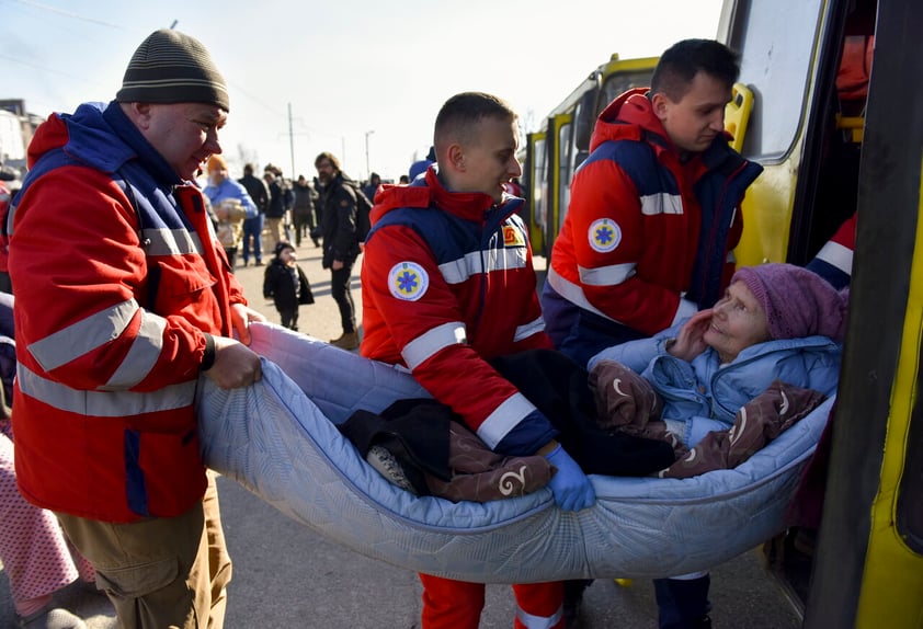 Kyiv (Ukraine), 14/03/2022.- Medical workers help an elderly woman after she was evacuated from a village nearby Kyiv occupied by the Russian army, to state-controlled territory in Bilihorodka village not far from Kyiv (Kiev), Ukraine, 14 March 2022. Russian troops entered Ukraine on 24 February prompting the country's president to declare martial law and triggering a series of announcements by Western countries to impose severe economic sanctions on Russia. (Atentado, Rusia, Ucrania) EFE/EPA/OLEG PETRASYUK