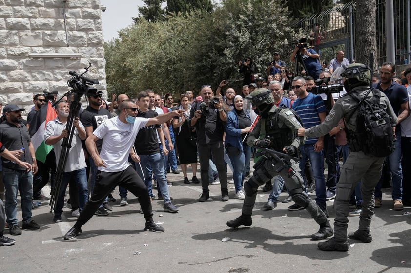 Israeli police confront mourners and journalists covering the funeral of slain Al Jazeera veteran journalist Shireen Abu Akleh in east Jerusalem, Friday, May 13, 2022. Abu Akleh, a Palestinian-American reporter who covered the Mideast conflict for more than 25 years, was shot dead Wednesday during an Israeli military raid in the West Bank town of Jenin. (AP Photo/Mahmoud Illean)