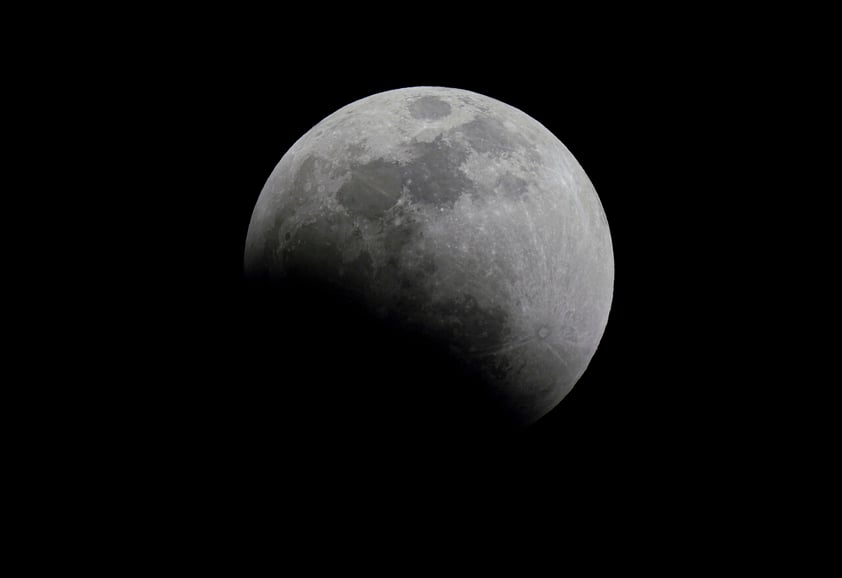 A lunar eclipse graces the night sky during the first blood moon of the year, in Mexico City, Sunday, May 15, 2022. (AP Photo/Fernando Llano)