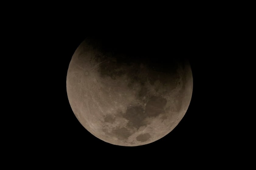 A lunar eclipse graces the night skies as it’s seen framed with the Juscelino Kubitschek Memorial during the first blood moon of the year, in Brasilia, Brazil, Sunday, May 15, 2022. (AP Photo/Eraldo Peres)