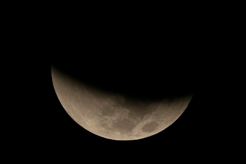 A lunar eclipse graces the night sky during the first blood moon of the year, in Brasilia, Brazil, Sunday, May 15, 2022. (AP Photo/Eraldo Peres)