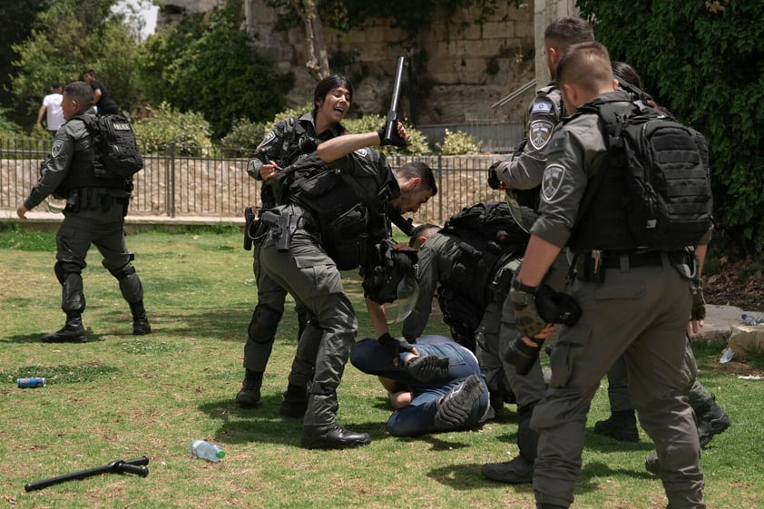 Members of Israeli security forces detain a Palestinian protester near Damascus Gate outside Jerusalem's Old City as Israelis mark Jerusalem Day, an Israeli holiday celebrating the capture of the Old City during the 1967 Mideast war. Sunday, May 29, 2022. Israel claims all of Jerusalem as its capital. But Palestinians, who seek east Jerusalem as the capital of a future state, see the march as a provocation. Last year, the parade helped trigger an 11-day war between Israel and Gaza militants. (AP Photo/Mahmoud Illean)