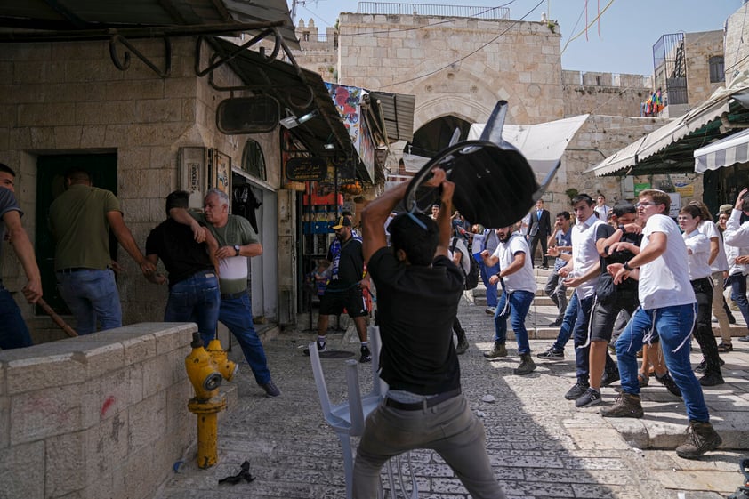 Palestinians and Jewish youths clash in Jerusalem's Old City as Israelis mark Jerusalem Day, an Israeli holiday celebrating the capture of the Old City during the 1967 Mideast war. Sunday, May 29, 2022. Israel claims all of Jerusalem as its capital. But Palestinians, who seek east Jerusalem as the capital of a future state, see the march as a provocation. Last year, the parade helped trigger an 11-day war between Israel and Gaza militants. (AP Photo/Ariel Schalit)