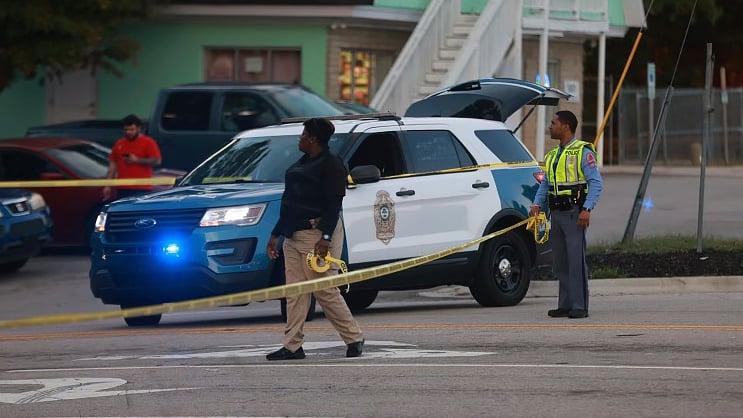 Law enforcement officers block off Old Milburnie Road during a shooting in Raleigh, N.C., Thursday, Oct. 13, 2022. (Robert Willett/The News & Observer via AP)