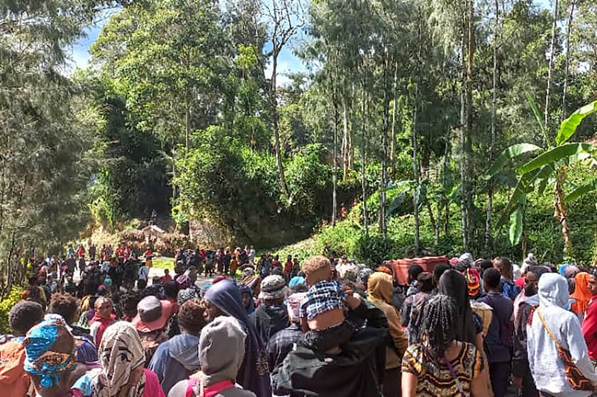 In this photo provided by the UNDP Papua New Guinea, villagers carry a coffin during a funeral procession in Yambali village in the Highlands of Papua New Guinea, Sunday, May 26, 2024. The International Organization for Migration feared Sunday the death toll from a massive landslide is much worse than what authorities initially estimated. (Kafuri Yaro/UNDP Papua New Guinea via AP)