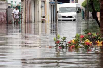 Habitantes del fraccionamiento Floresta sacan el agua de sus viviendas, las cuales se inundaron debido a las fuertes lluvias y a que el personal de Sistema de Agua y Saneamiento no encendió las bombas. (El Universal)