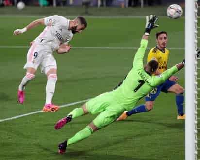 Karim Benzema marca de cabeza su segundo gol del juego y el tercero del Madrid, en el triunfo 3-0 ante Cádiz. (EFE)