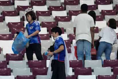 Los seguidores nipones fueron a lo suyo, a lo que tocaba, y dedicaron unos cuantos minutos a limpiar. (AP)